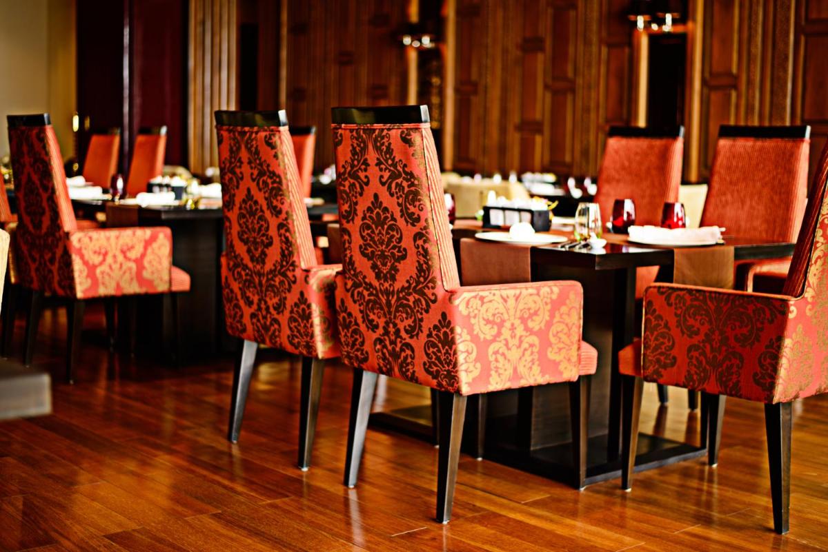 a dining room with a table and chairs at Taj City Centre Gurugram in Gurgaon