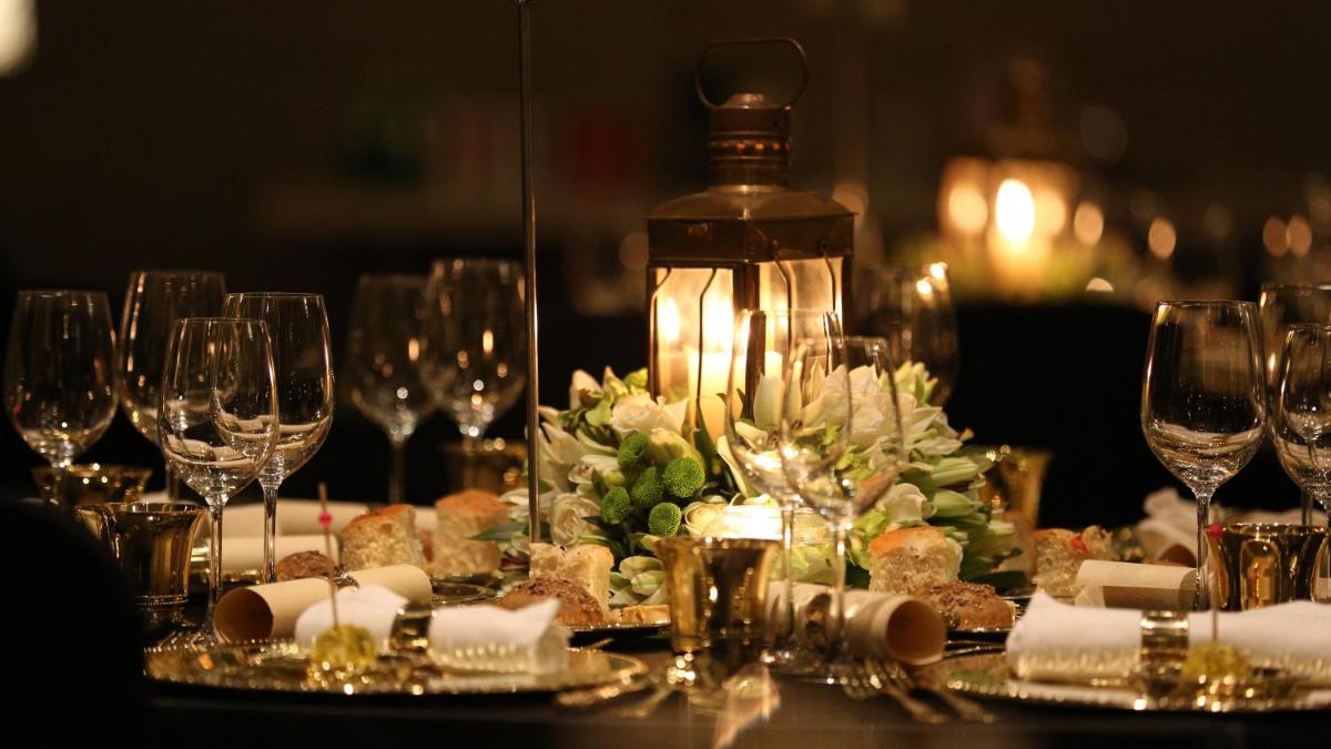 a table with wine glasses and food on it at Taj City Centre Gurugram in Gurgaon