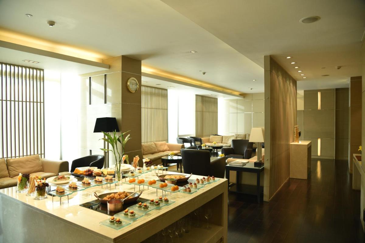 a lobby with a table with food on it at Taj City Centre Gurugram in Gurgaon