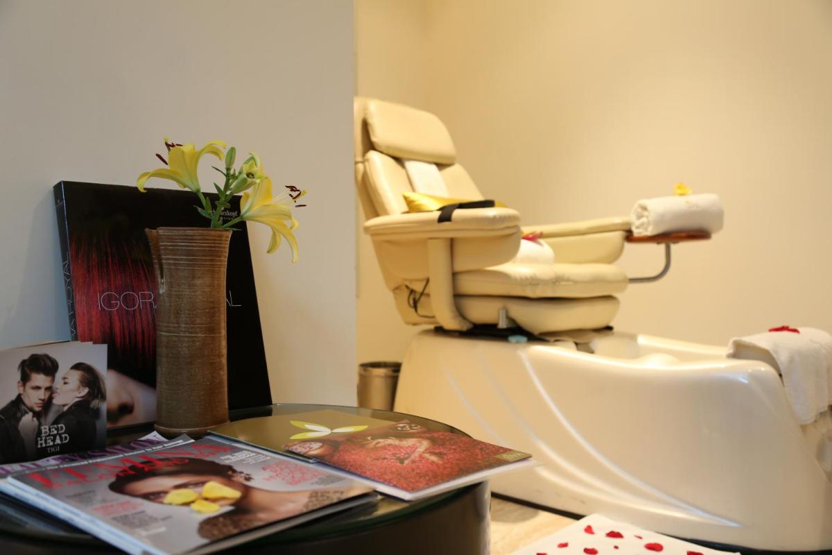 a bathroom with a toilet and a table with a magazine at Taj City Centre Gurugram in Gurgaon