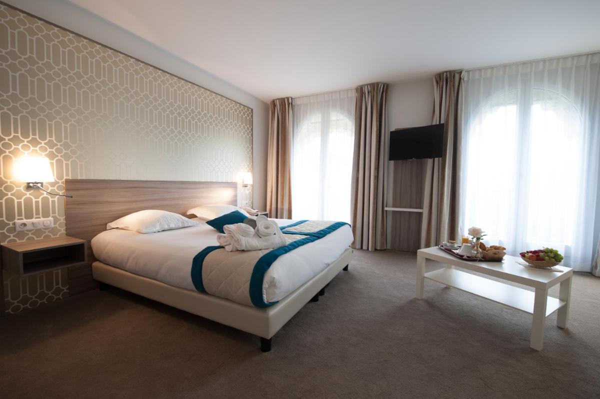 Un ou plusieurs lits dans un hébergement de l'établissement Hotel & Spa Radiana