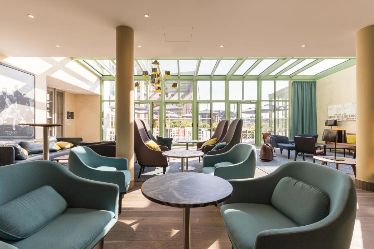 Coin salon dans l'établissement Résidence Pierre & Vacances Premium Presqu'Ile de la Touques