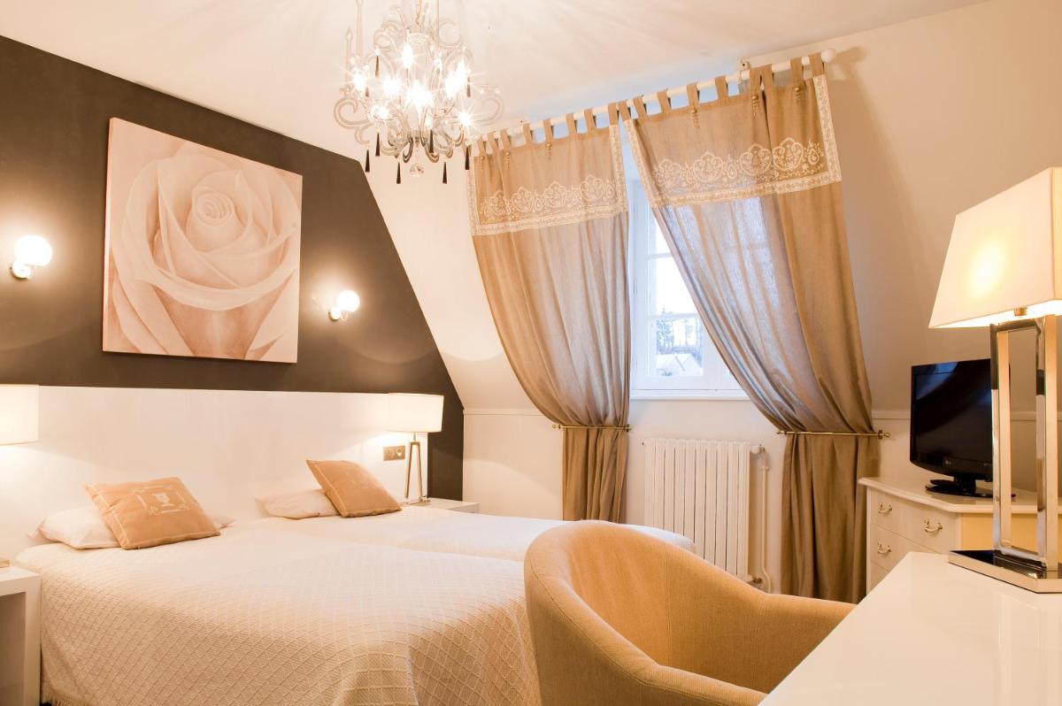 Un ou plusieurs lits dans un hébergement de l'établissement Le Bailliage Hôtel & Spa