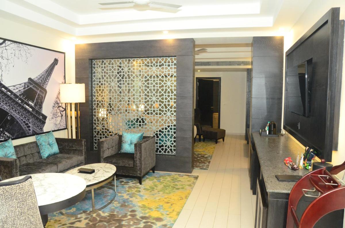 a living room with a couch and a table at Radisson Chandigarh Zirakpur in Chandīgarh