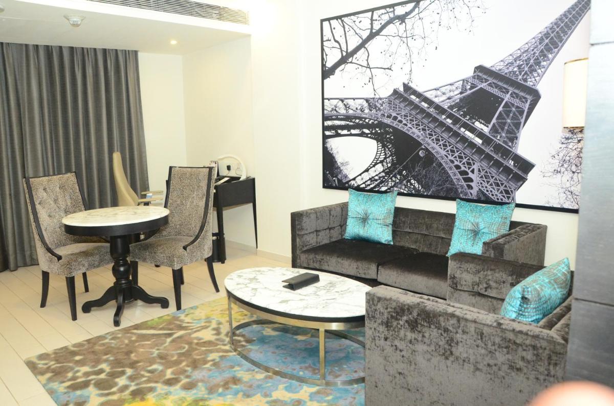 a room with a table and a picture of the eiffel tower at Radisson Chandigarh Zirakpur in Chandīgarh