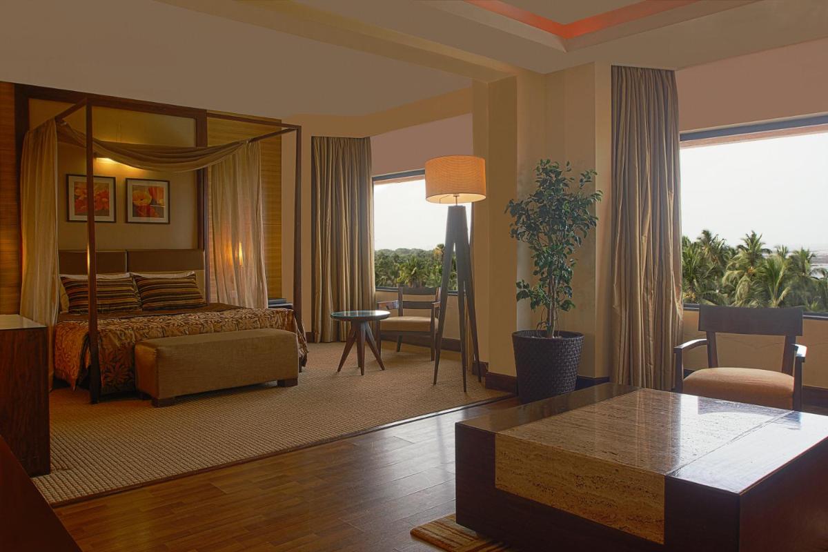 a hotel room with a bed and a living room at The Retreat Hotel & Convention Centre in Mumbai