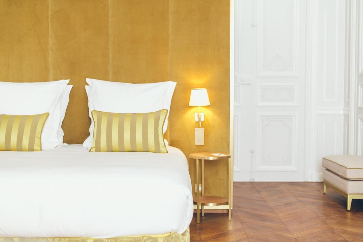 Un ou plusieurs lits dans un hébergement de l'établissement Hôtel Alfred Sommier