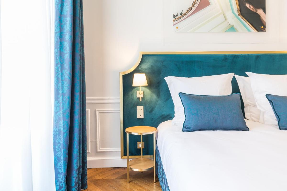 Un ou plusieurs lits dans un hébergement de l'établissement Hôtel Alfred Sommier