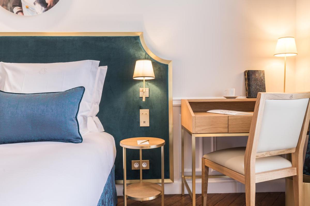 Un ou plusieurs lits dans un hébergement de l'établissement Hôtel Alfred Sommier