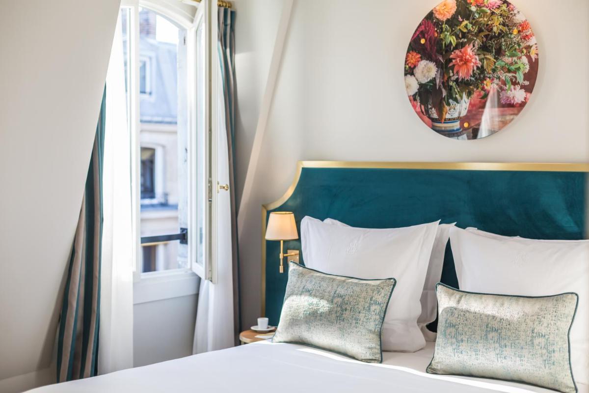 Un ou plusieurs lits dans un hébergement de l'établissement Hôtel Alfred Sommier