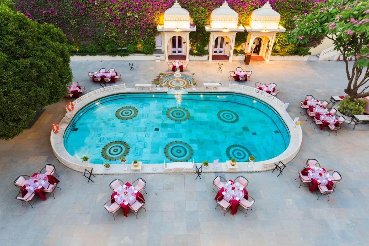 an overhead view of a pool with tables and chairs at Shiv Niwas Palace by HRH Group of Hotels in Udaipur