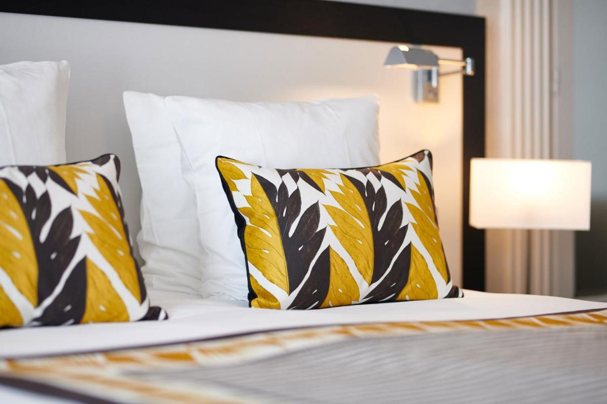 Un ou plusieurs lits dans un hébergement de l'établissement Hotel & Spa Vacances Bleues Le Splendid