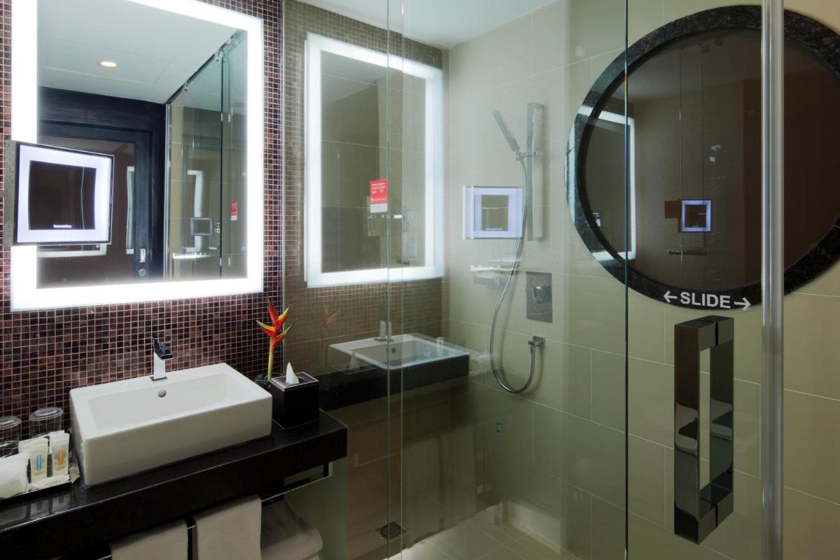 a bathroom with a sink and a mirror at The Oterra in Bengaluru