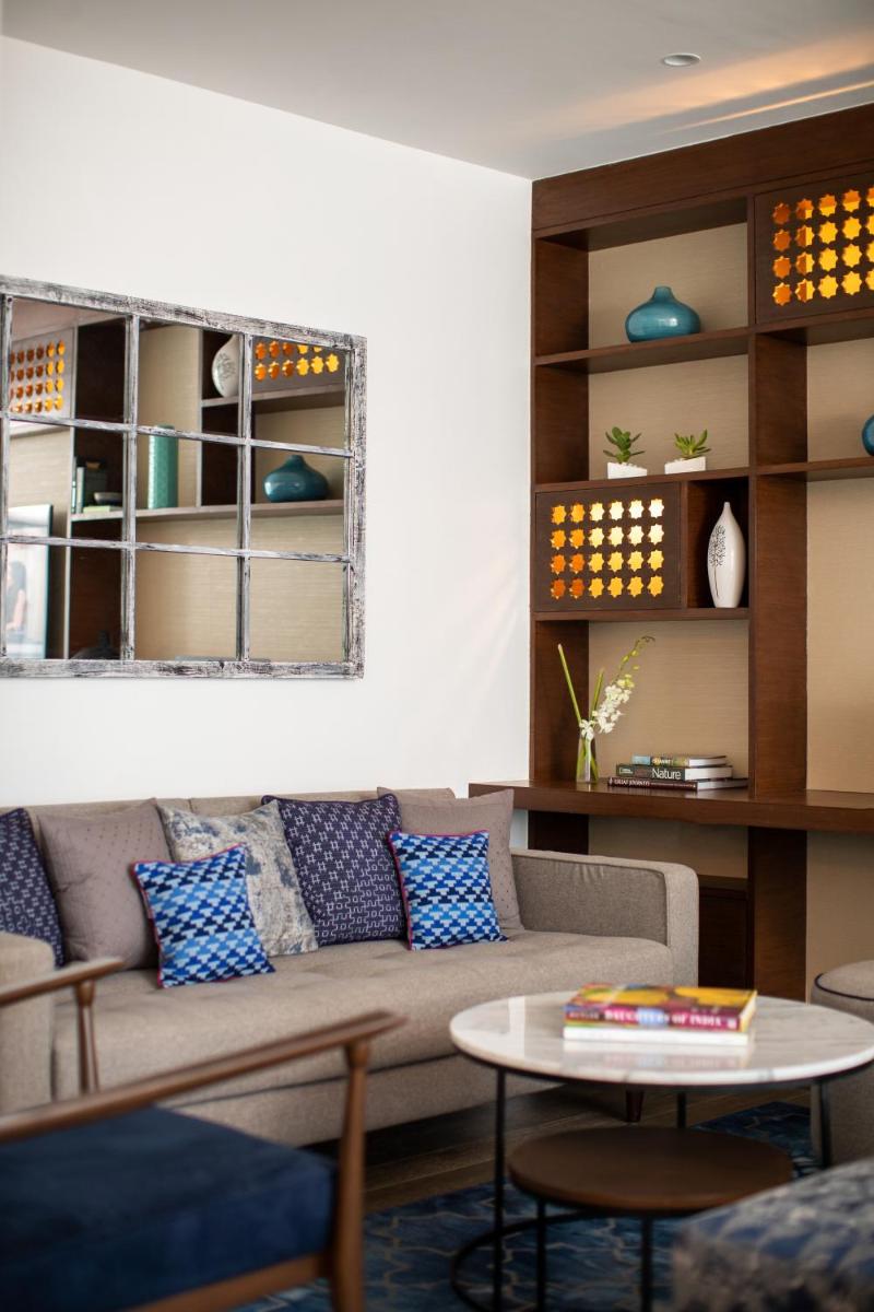 a living room with a couch and a table at Renaissance Ahmedabad Hotel in Ahmedabad