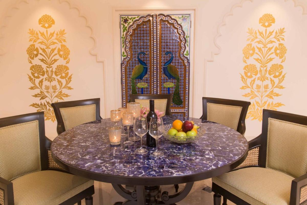 a dining room table with a bowl of fruit on it at Taj Bengal in Kolkata