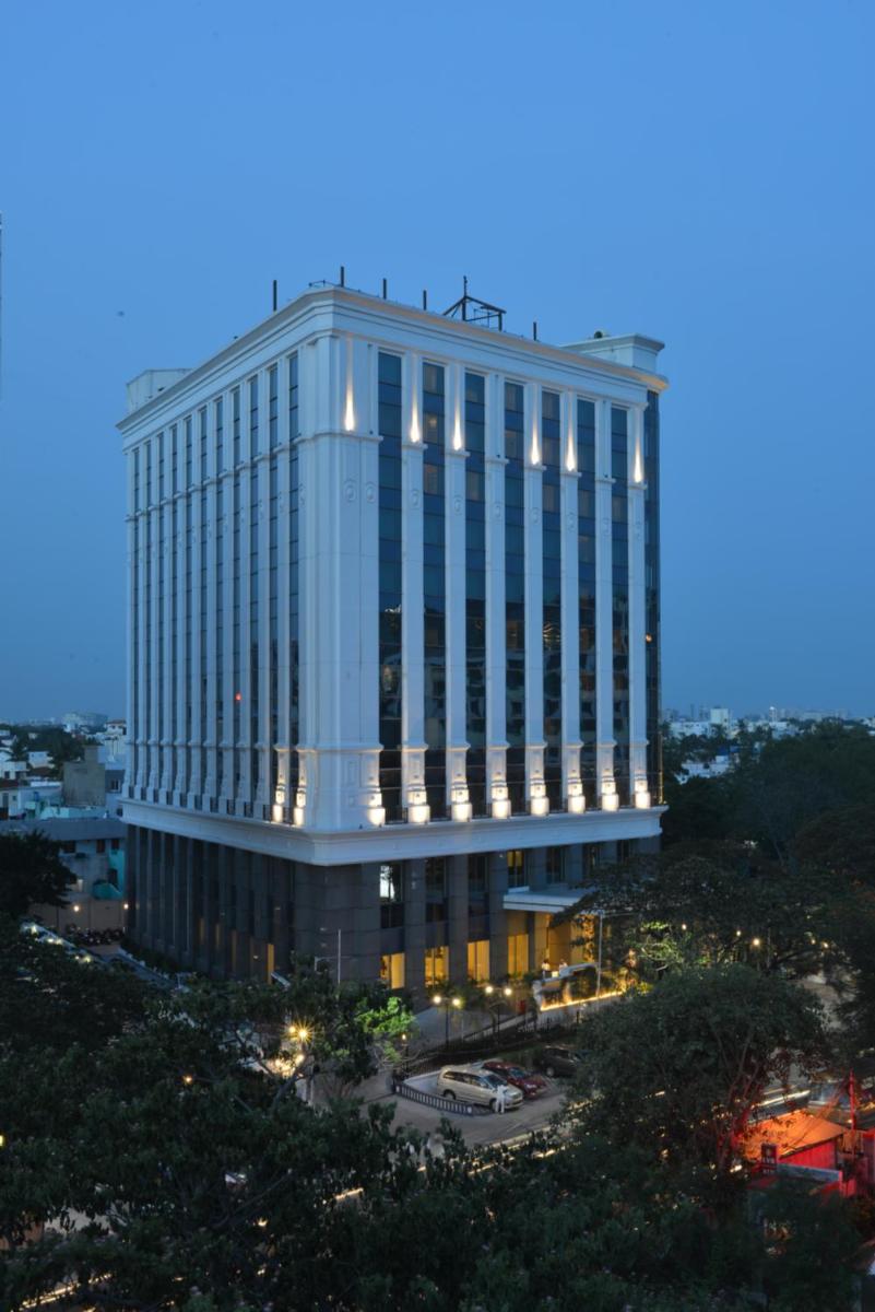 a tall building with a lot of windows at Ramada Plaza Chennai in Chennai