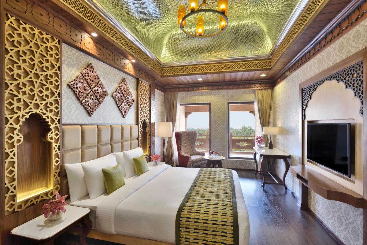 a bedroom with a large bed and a ceiling at Radisson Jodhpur in Jodhpur