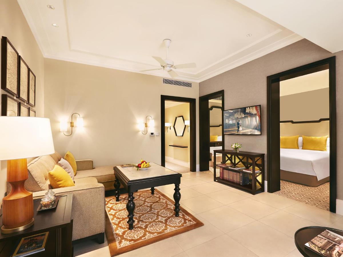 a living room with a couch and a bed at Taj Connemara, Chennai in Chennai