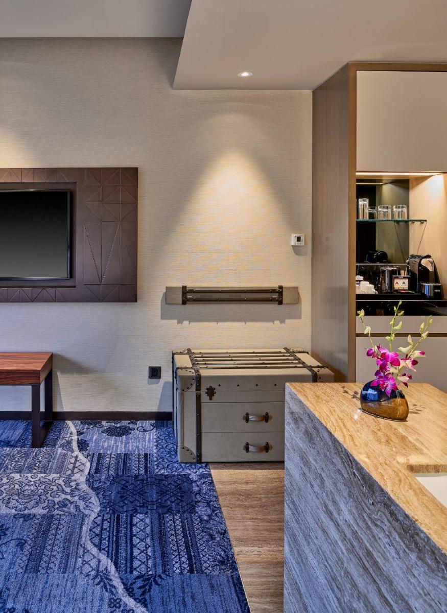a kitchen with a stove and a counter top at The Den, Bengaluru in Bengaluru