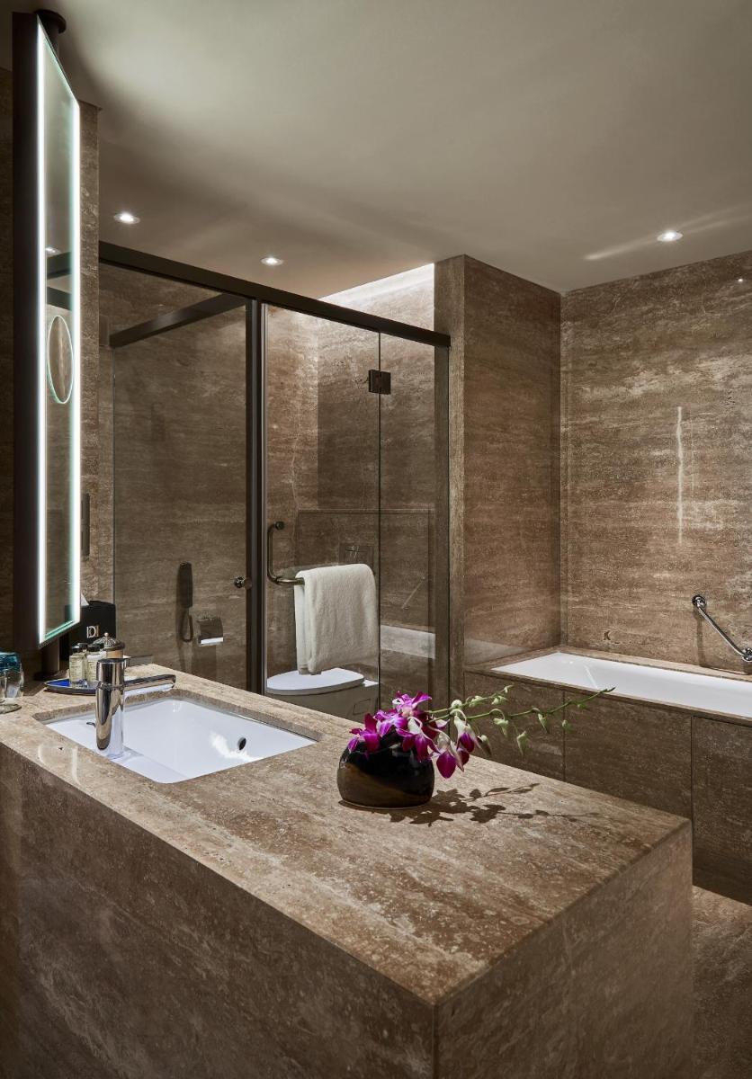 a bathroom with a bath tub and a sink at The Den, Bengaluru in Bengaluru