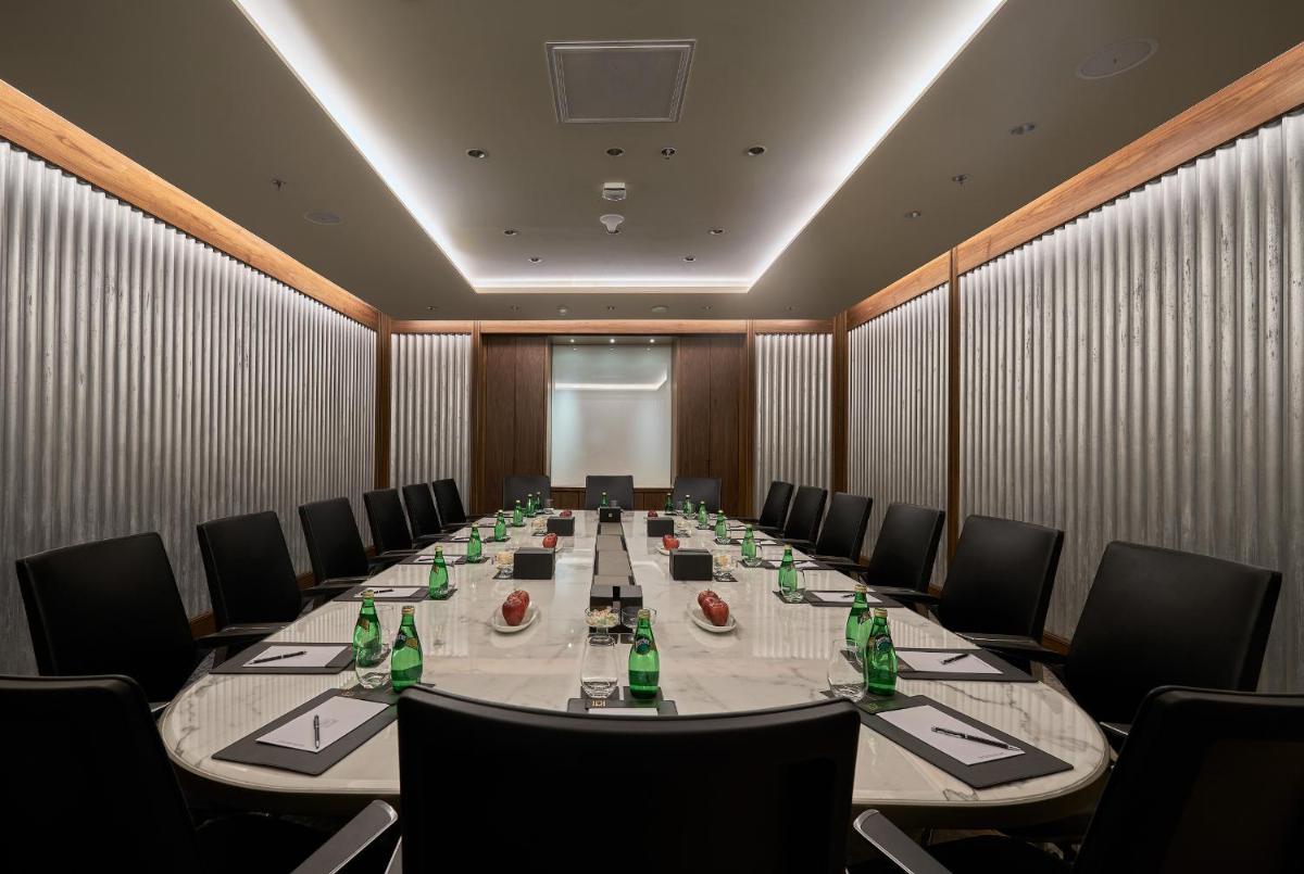a conference room with a long table and chairs at The Den, Bengaluru in Bengaluru