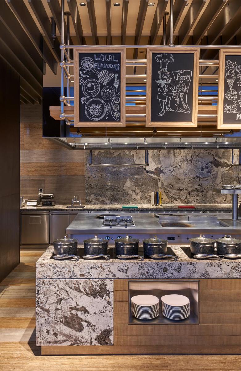 a kitchen with a counter with pots and pans at The Den, Bengaluru in Bengaluru