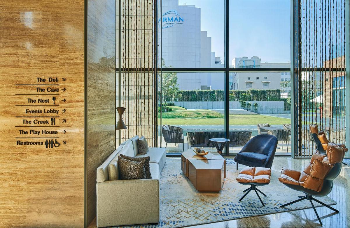 a living room with two chairs and a couch and a table at The Den, Bengaluru in Bengaluru