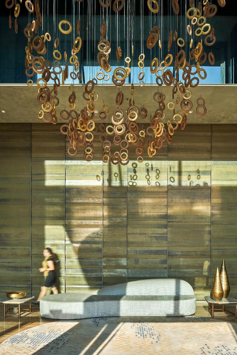 a chandelier hangs from a wall in a room at The Den, Bengaluru in Bengaluru