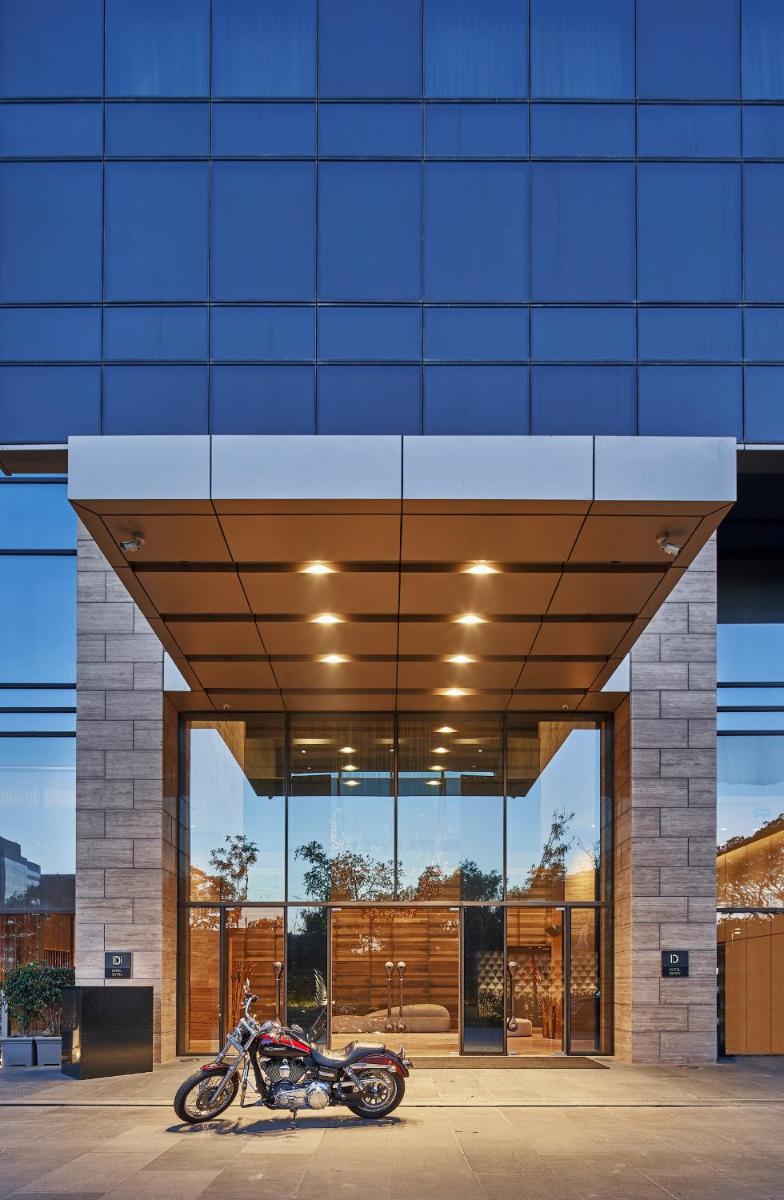 a motorcycle parked in front of a building at The Den, Bengaluru in Bengaluru