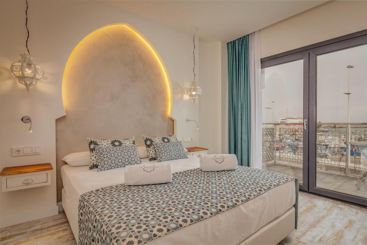 Cama o camas de una habitación en La Residencia Puerto Hotel & Spa