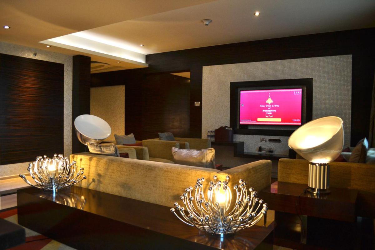 a living room with a couch and a tv at Vivanta Hyderabad, Begumpet in Hyderabad a living room with a couch and a tv at Vivanta Hyderabad, Begumpet in Hyderabad