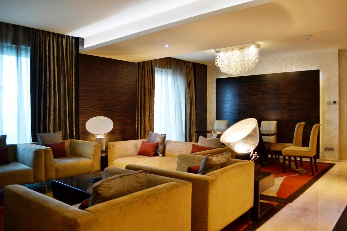 a living room with couches and a couch and chairs at Vivanta Hyderabad, Begumpet in Hyderabad a living room with couches and a couch and chairs at Vivanta Hyderabad, Begumpet in Hyderabad