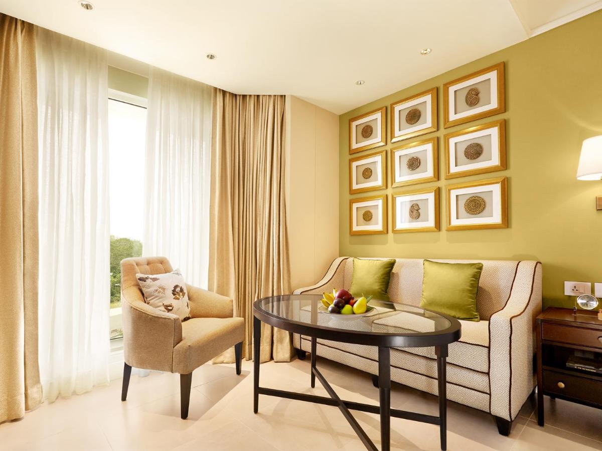 a living room with a couch and a table at Taj Connemara, Chennai in Chennai