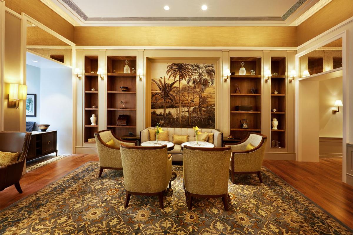 a dining room with a table and chairs at Taj Connemara, Chennai in Chennai