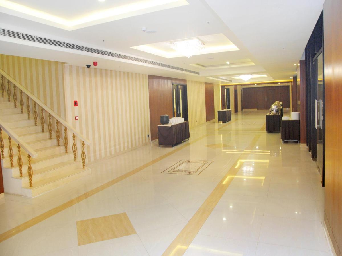 a hallway of a building with stairs and tables at Fortune Select Grand Ridge, Tirupati - Member ITC Hotels' Group in Tirupati