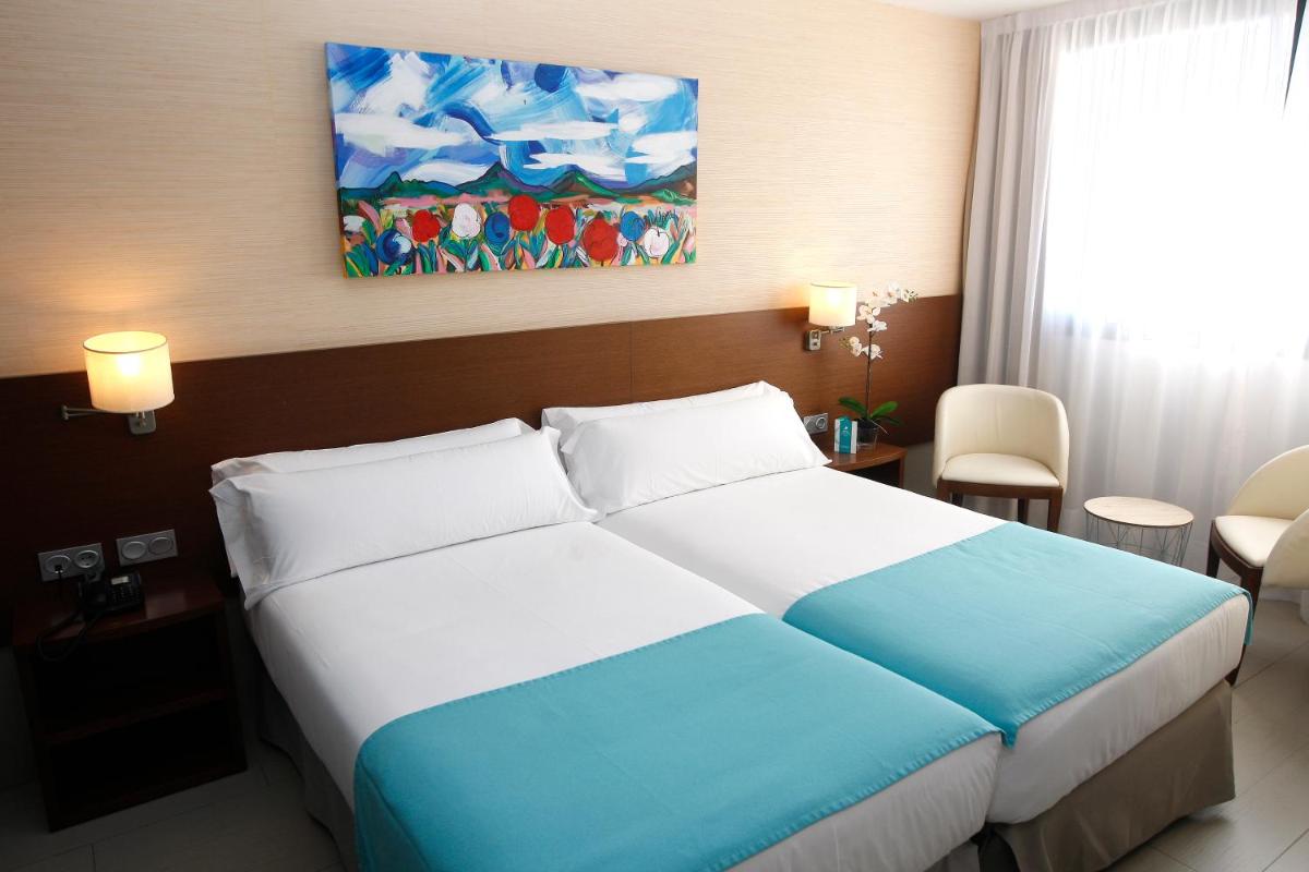 Cama o camas de una habitación en Hotel & Spa Real Ciudad De Zaragoza