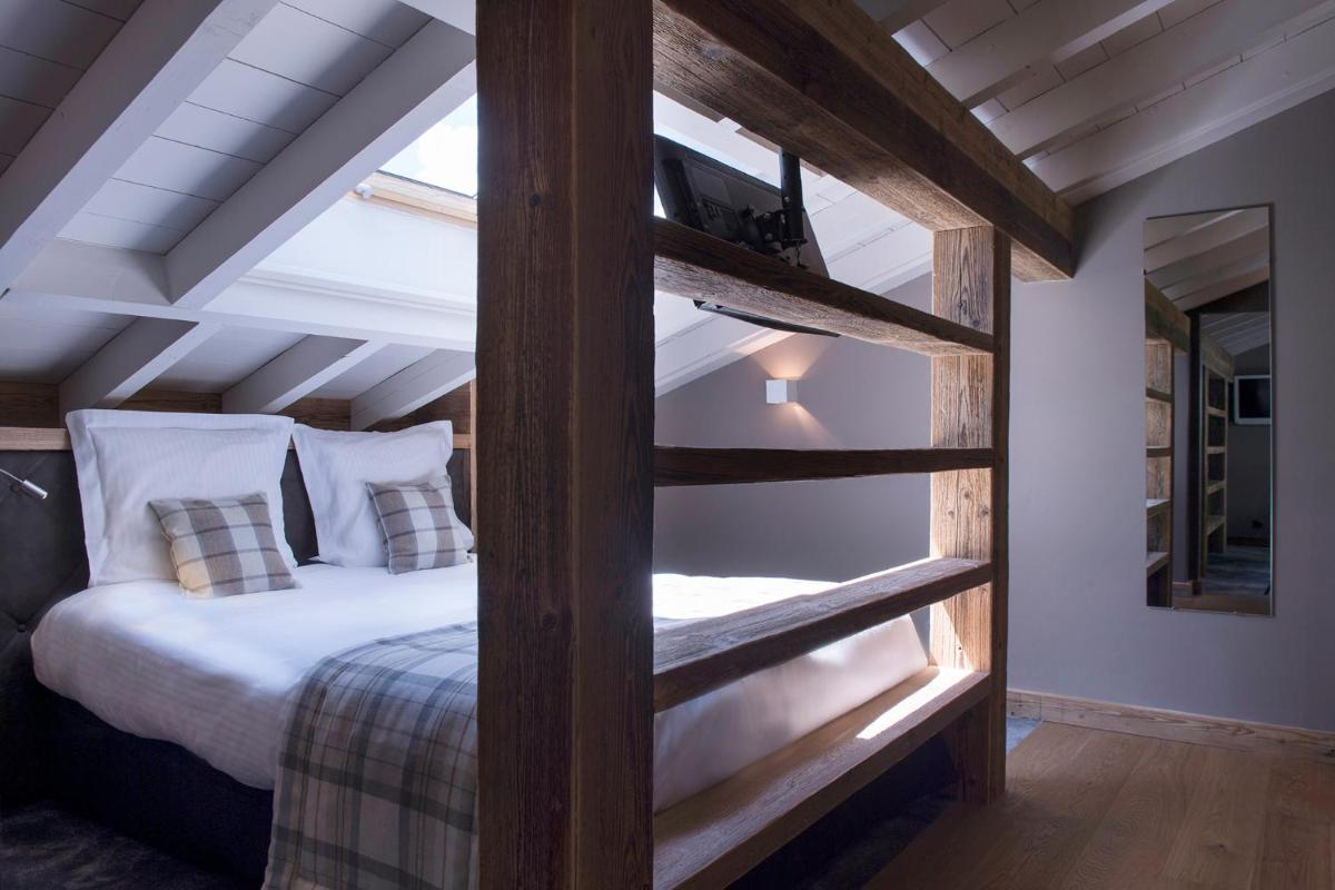 Un ou plusieurs lits dans un hébergement de l'établissement Les Gentianettes Hotel & Spa