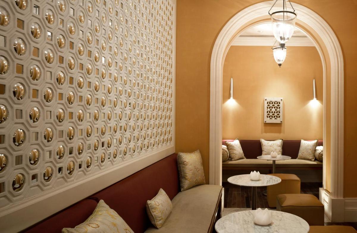 a waiting room with a couch and two tables at Jai Mahal Palace in Jaipur