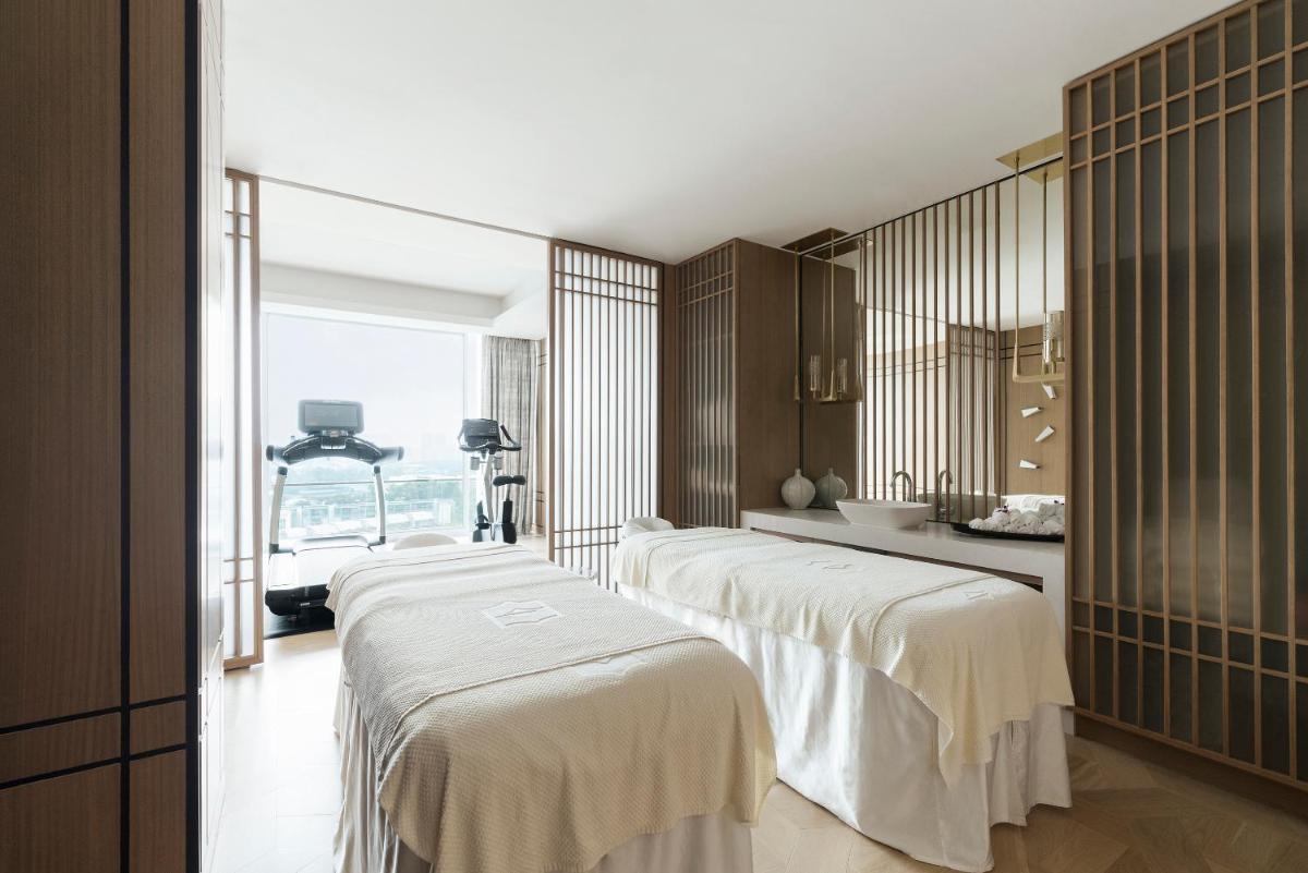 a group of four beds in a room at Shangri-La Singapore in Singapore