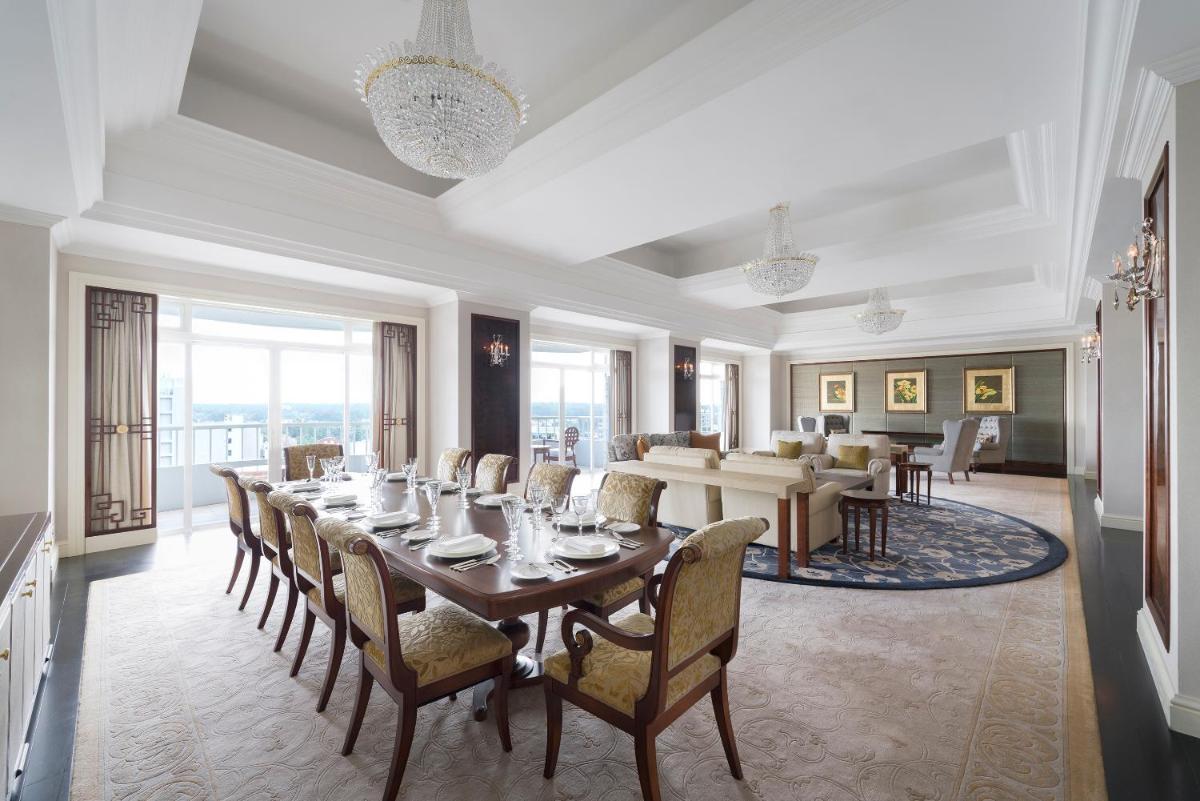 a dining room with a long table and chairs at Shangri-La Singapore in Singapore a dining room with a long table and chairs at Shangri-La Singapore in Singapore