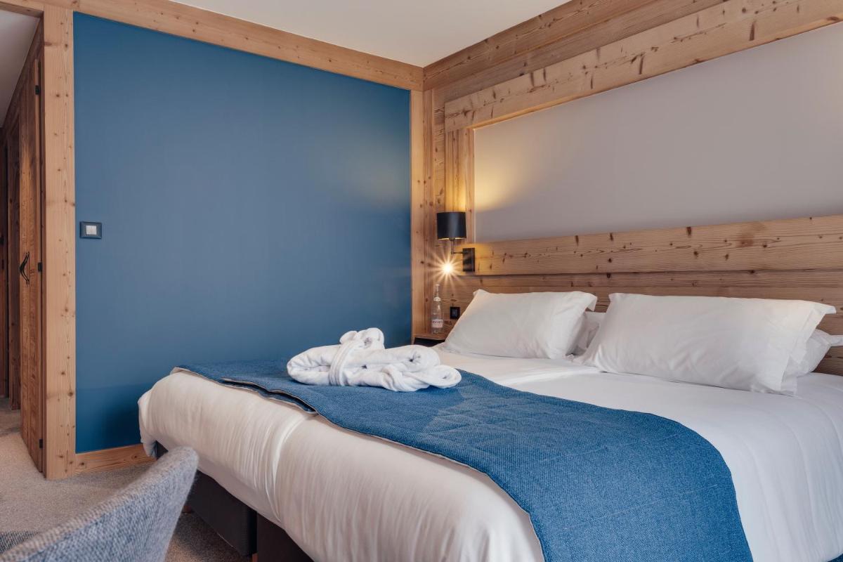 Un ou plusieurs lits dans un hébergement de l'établissement Hôtel Avancher