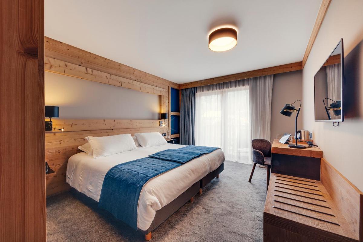 Un ou plusieurs lits dans un hébergement de l'établissement Hôtel Avancher