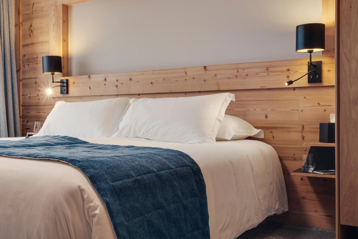 Un ou plusieurs lits dans un hébergement de l'établissement Hôtel Avancher
