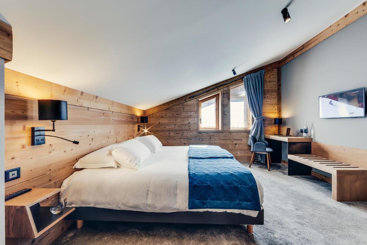 Un ou plusieurs lits dans un hébergement de l'établissement Hôtel Avancher