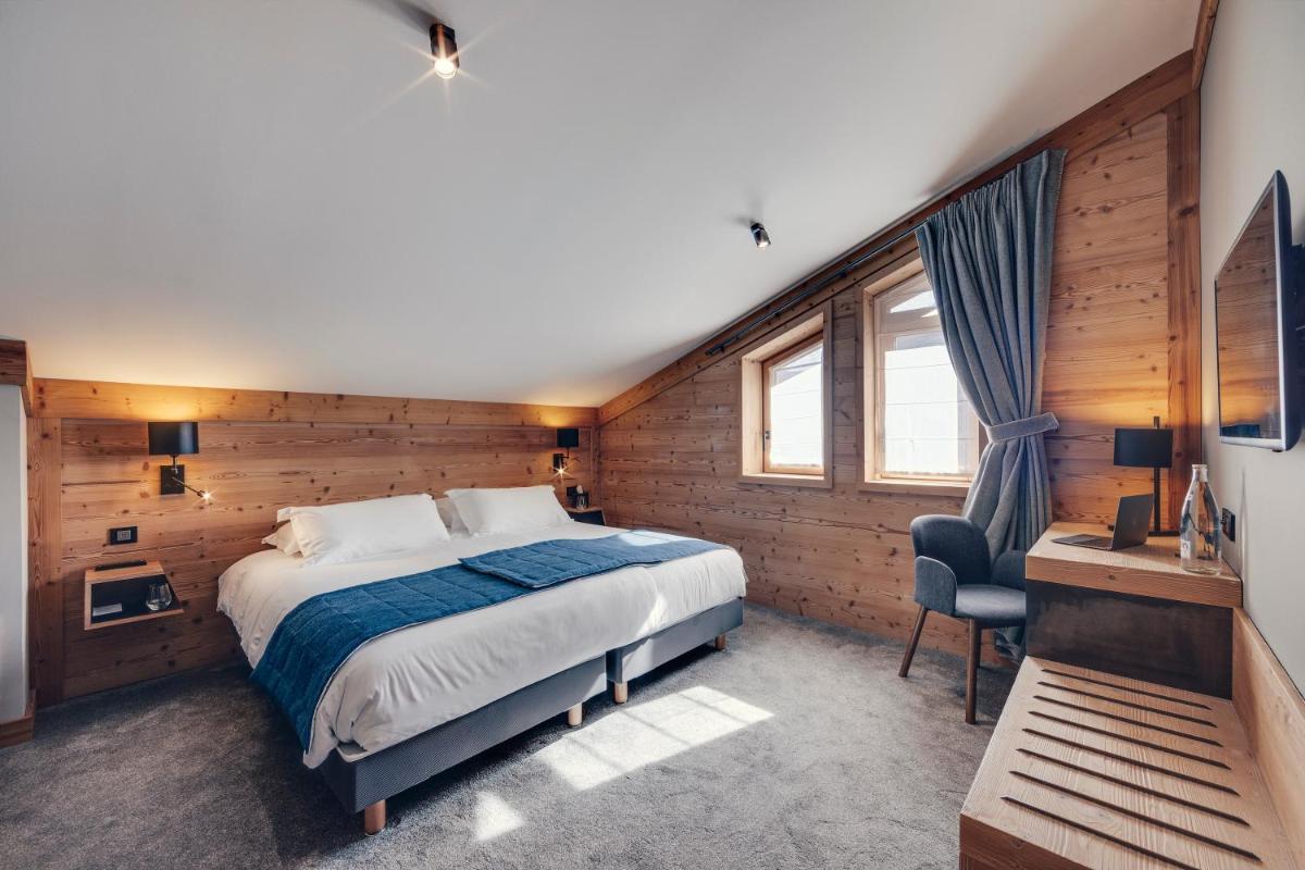 Un ou plusieurs lits dans un hébergement de l'établissement Hôtel Avancher