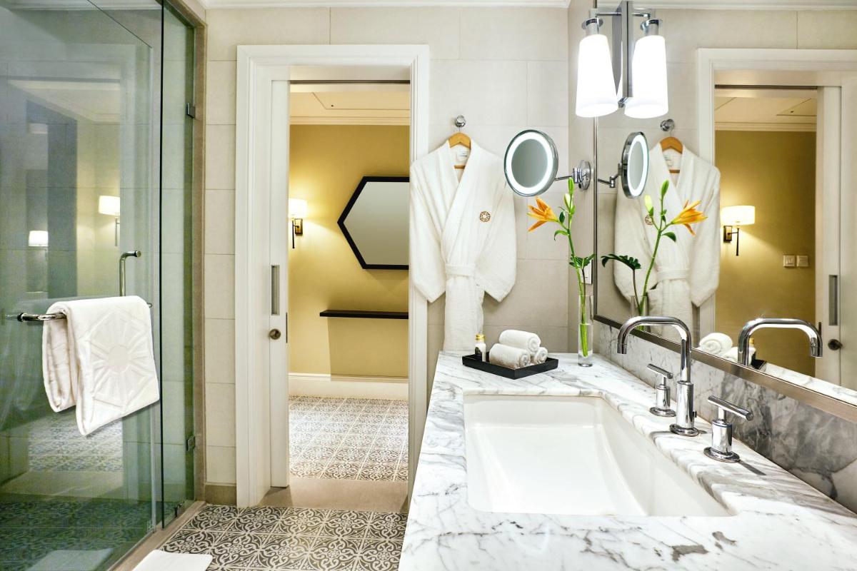 a bathroom with a large sink and a shower at Taj Connemara, Chennai in Chennai
