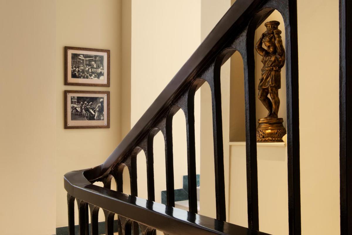 a stairway with a statue of a woman at Taj Connemara, Chennai in Chennai