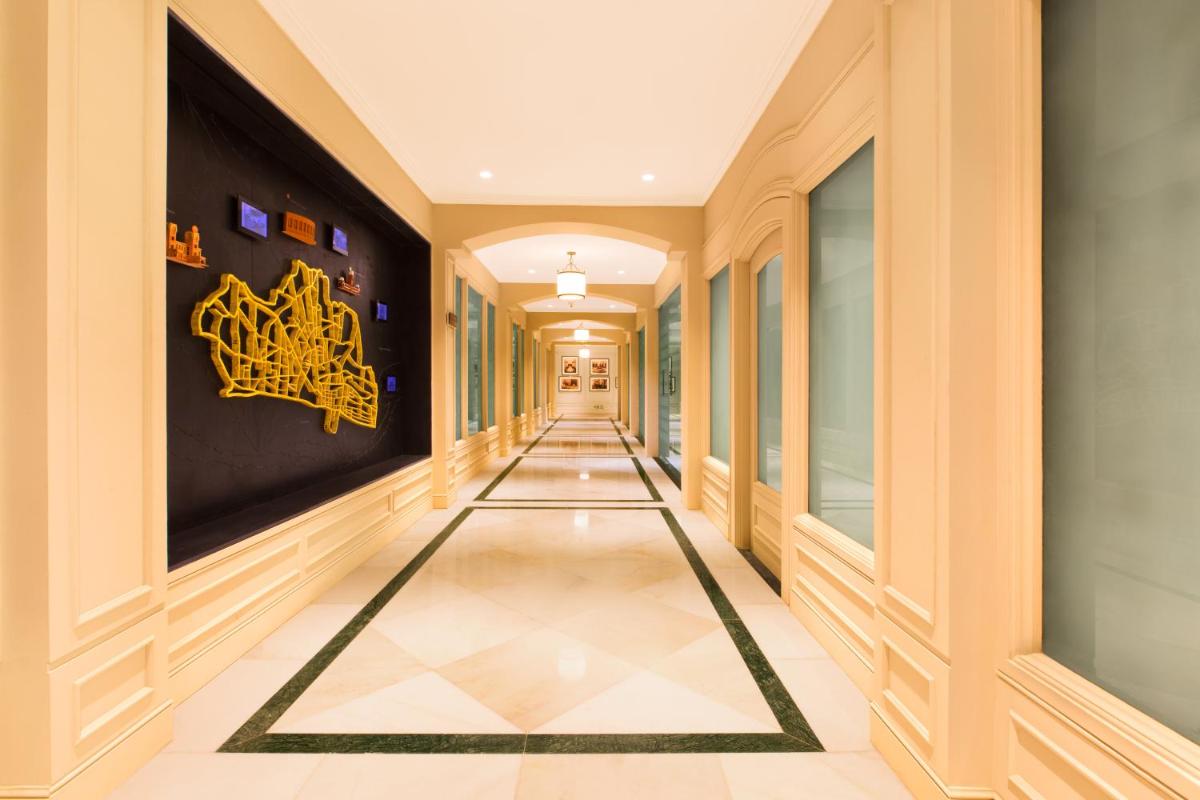 a corridor of a building with a long hallway at Taj Connemara, Chennai in Chennai