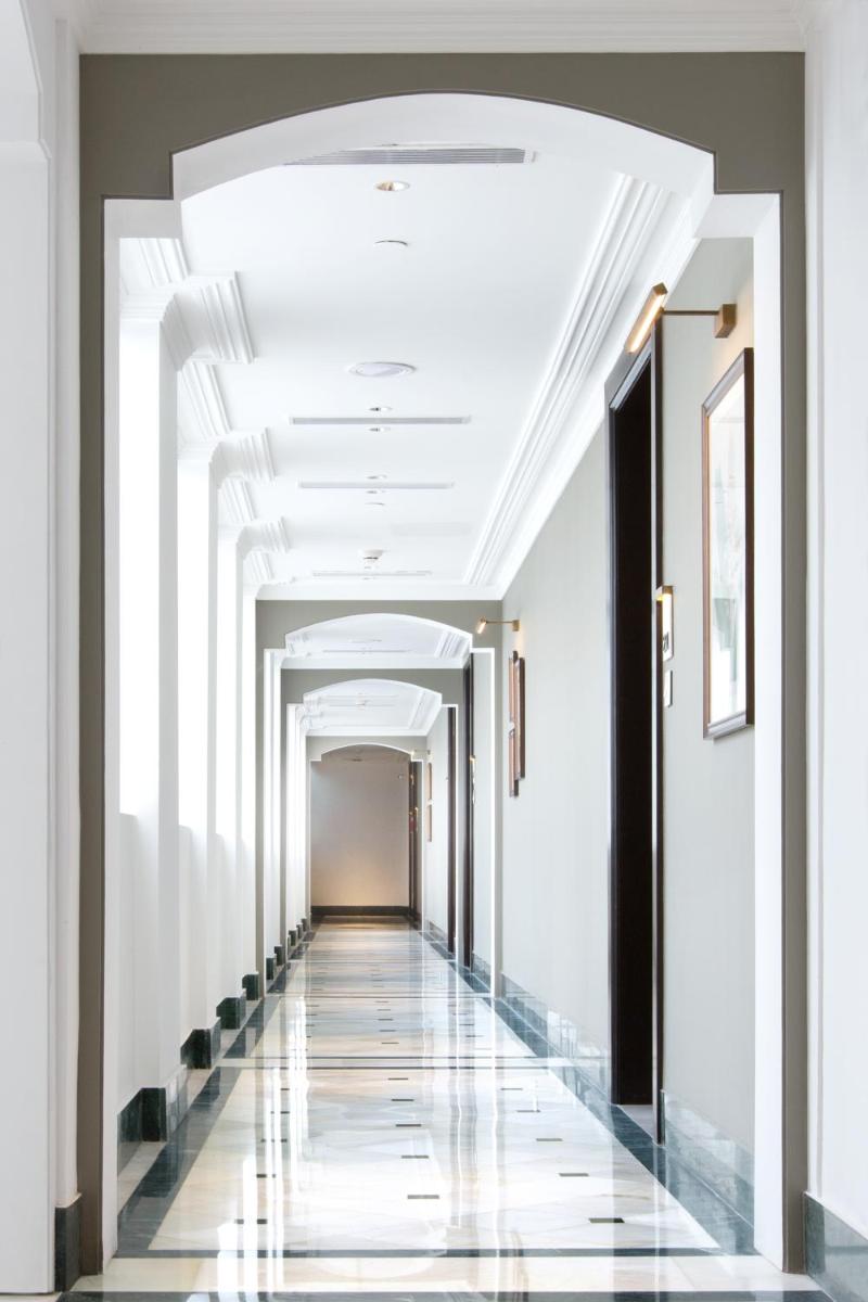 a hallway in a building with a white ceiling at Taj Connemara, Chennai in Chennai