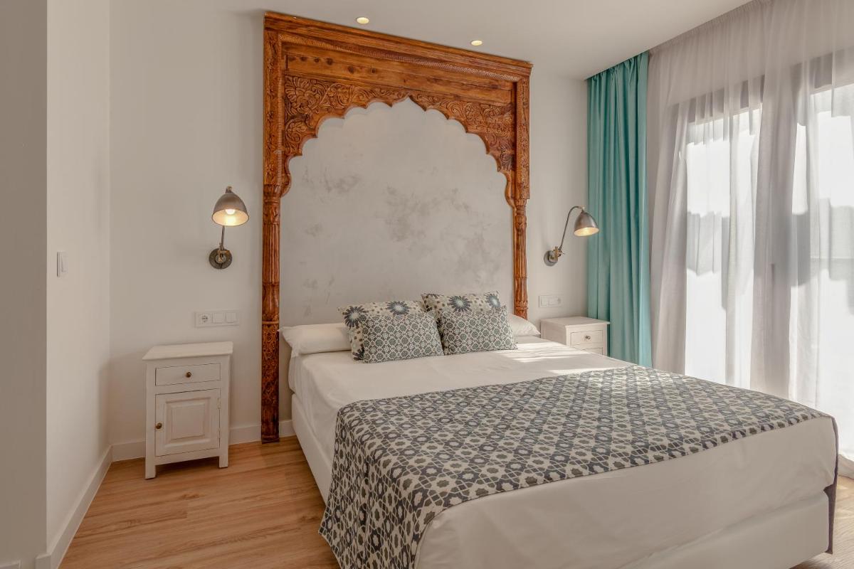 Cama o camas de una habitación en La Residencia Puerto Hotel & Spa